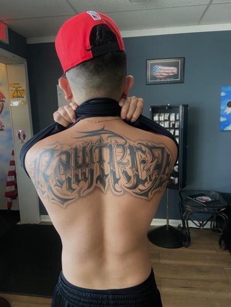 Izzy Tattoo Artist - Black and grey script back piece